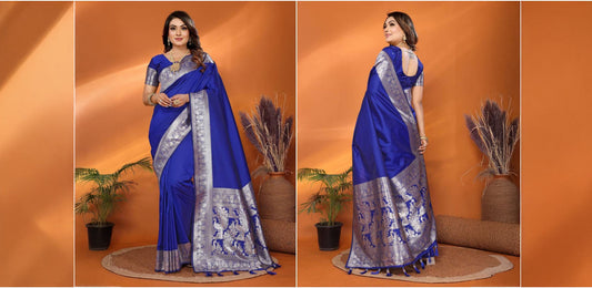 Woman wearing a royal blue Banarasi silk saree with intricate silver zari work, posed in traditional indoor setting, high quality clothing