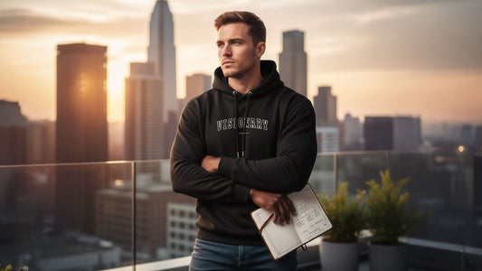 Outdoor shot of a man wearing a motivational hoodie from the Wear Grit Brand, embodying the focused action, discipline, and success psychology required for the millionaire mindset and achieving financial freedom.