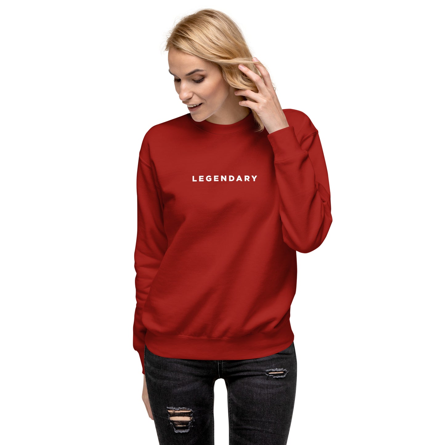 A female model wearing red Legendary motivational grit sweatshirt for achievers focused on growth, discipline, and long-term success by wear grit brand clothing