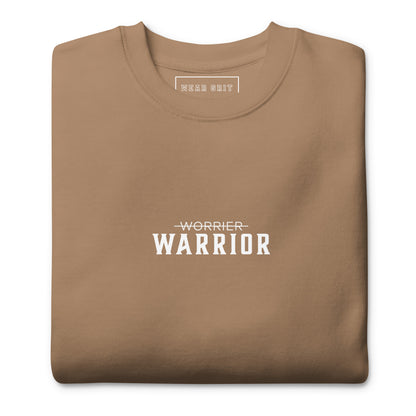 Folded brown sweatshirt with 'Worrier Warrior' text on a white background from wear grit clothing brand