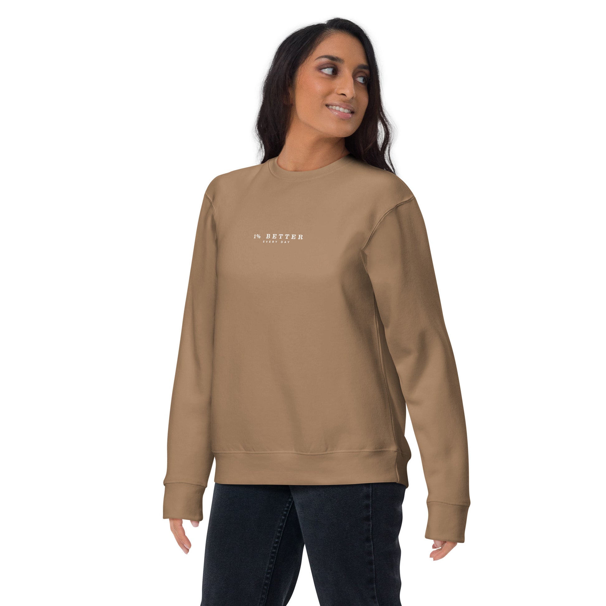a female model wearing 1% Better Every Day — Motivational Grit biege Sweatshirt; mindset apparel for leaders and achievers focused on growth and discipline by wear grit brand clothing