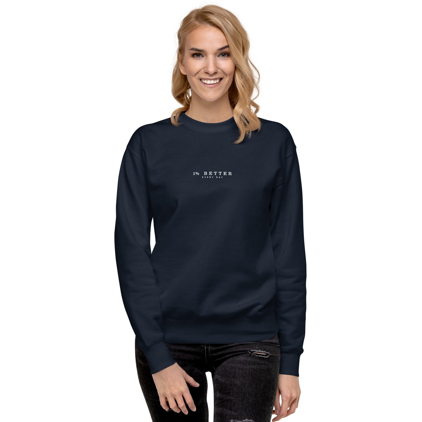 a female model with a navy sweater with a print 1% Better Every Day — Motivational Grit Sweatshirt; mindset apparel for leaders and achievers focused on growth and discipline by wear grit brand clothing