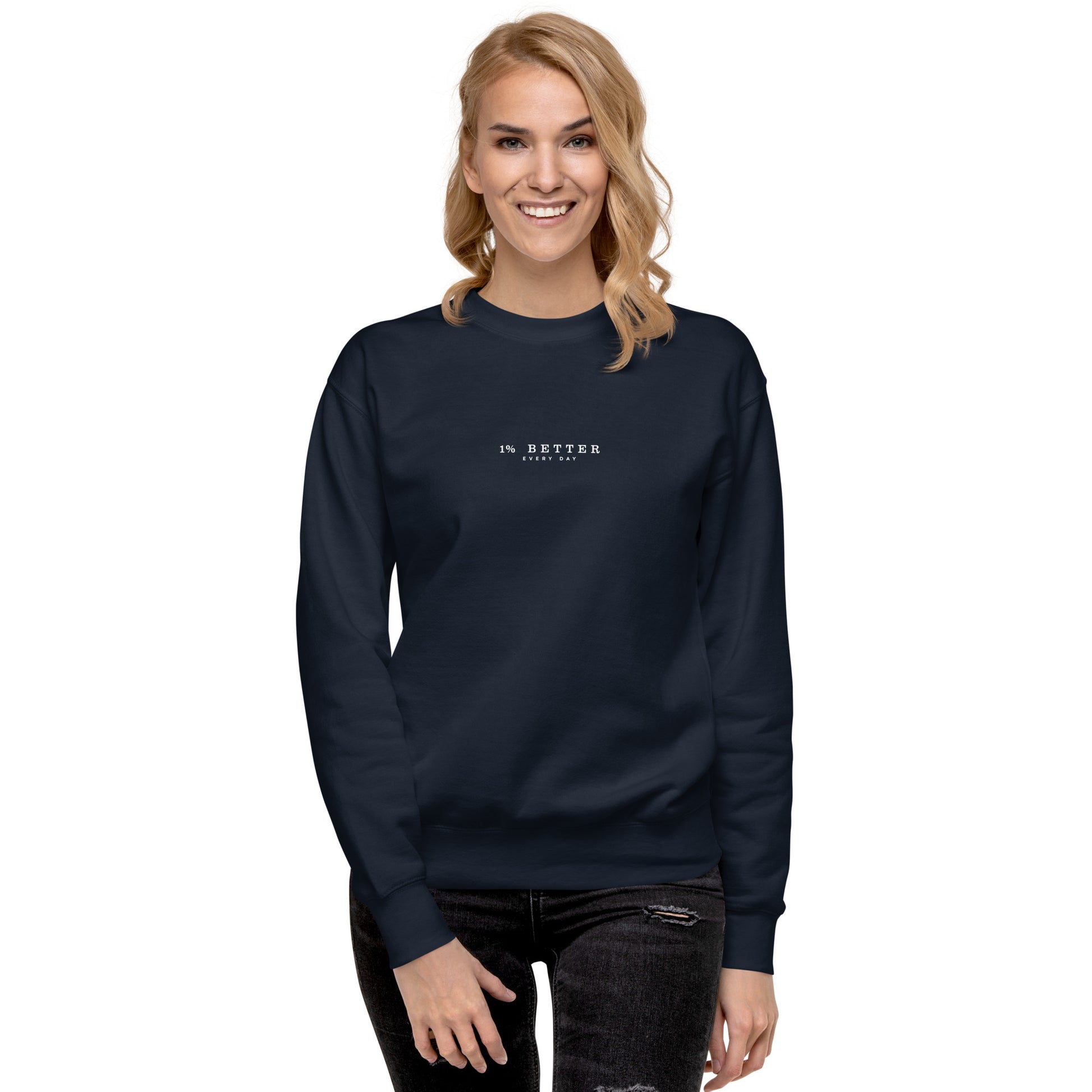 a female model with a navy sweater with a print 1% Better Every Day — Motivational Grit Sweatshirt; mindset apparel for leaders and achievers focused on growth and discipline by wear grit brand clothing