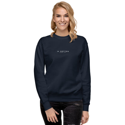 a female model with a navy sweater with a print 1% Better Every Day — Motivational Grit Sweatshirt; mindset apparel for leaders and achievers focused on growth and discipline by wear grit brand clothing