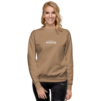 a lady wearing a cream long-sleeve shirt with 'WARRIOR' printed on it, a high-quality motivational and mindset-driven sweatshirt apparel by wear grit brand clothing