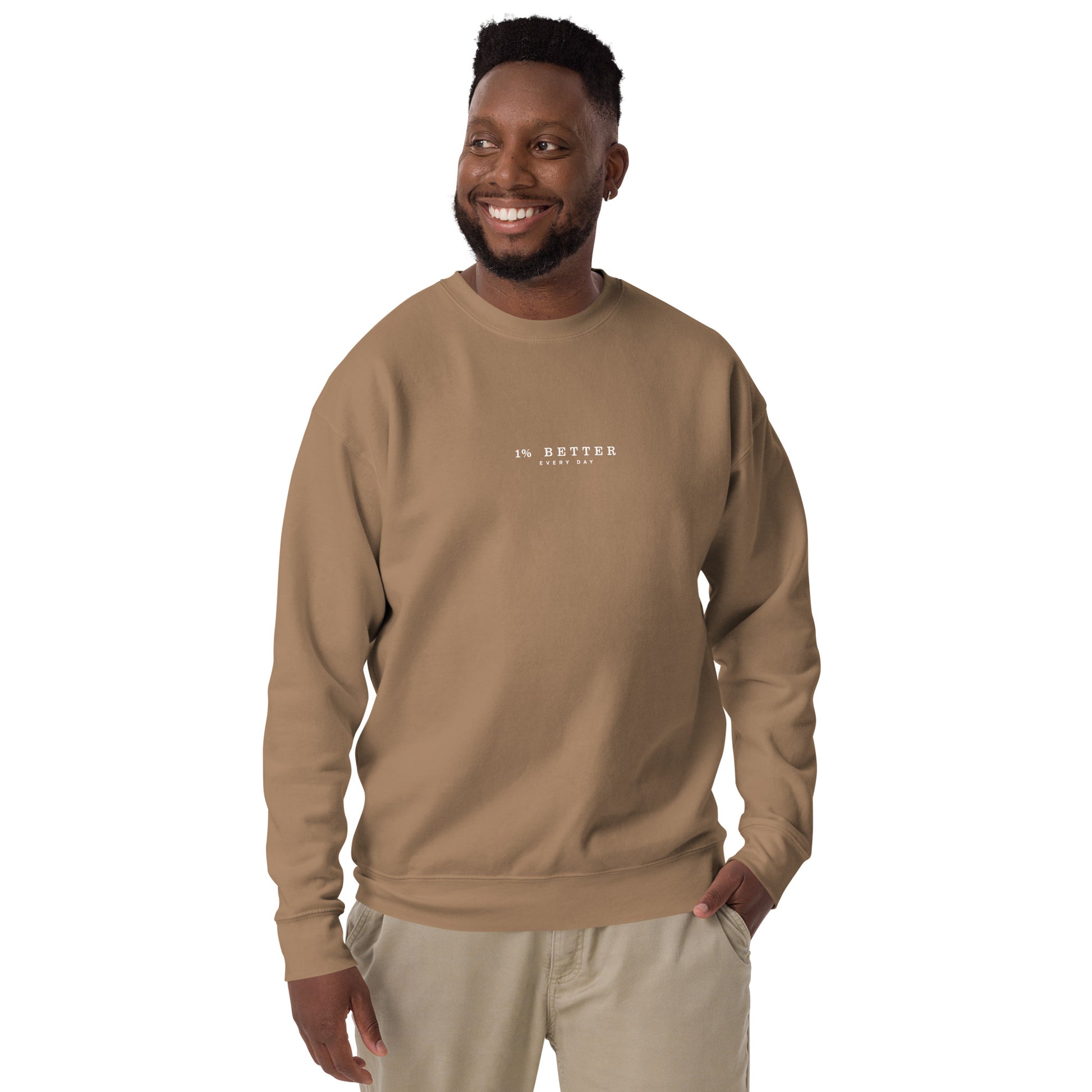 a model with a cream sweater with a print 1% Better Every Day — Motivational Grit Sweatshirt; mindset apparel for leaders and achievers focused on growth and discipline by wear grit brand clothing