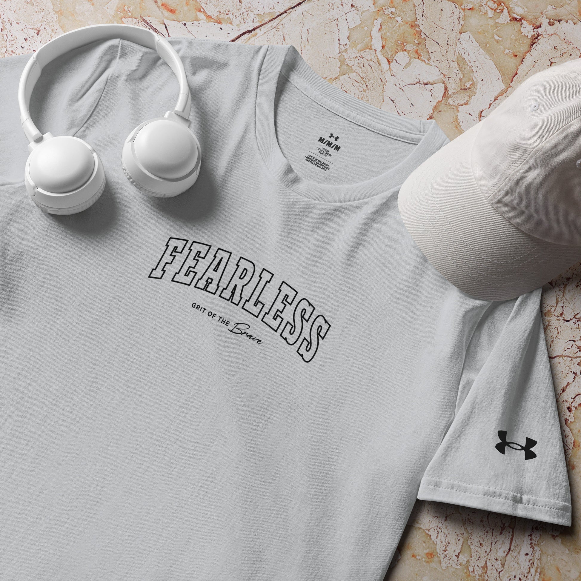 a product shot of grey Fearless Under ArmourⓇ fitness t-shirt for training and workouts with relaxed fit and split hem