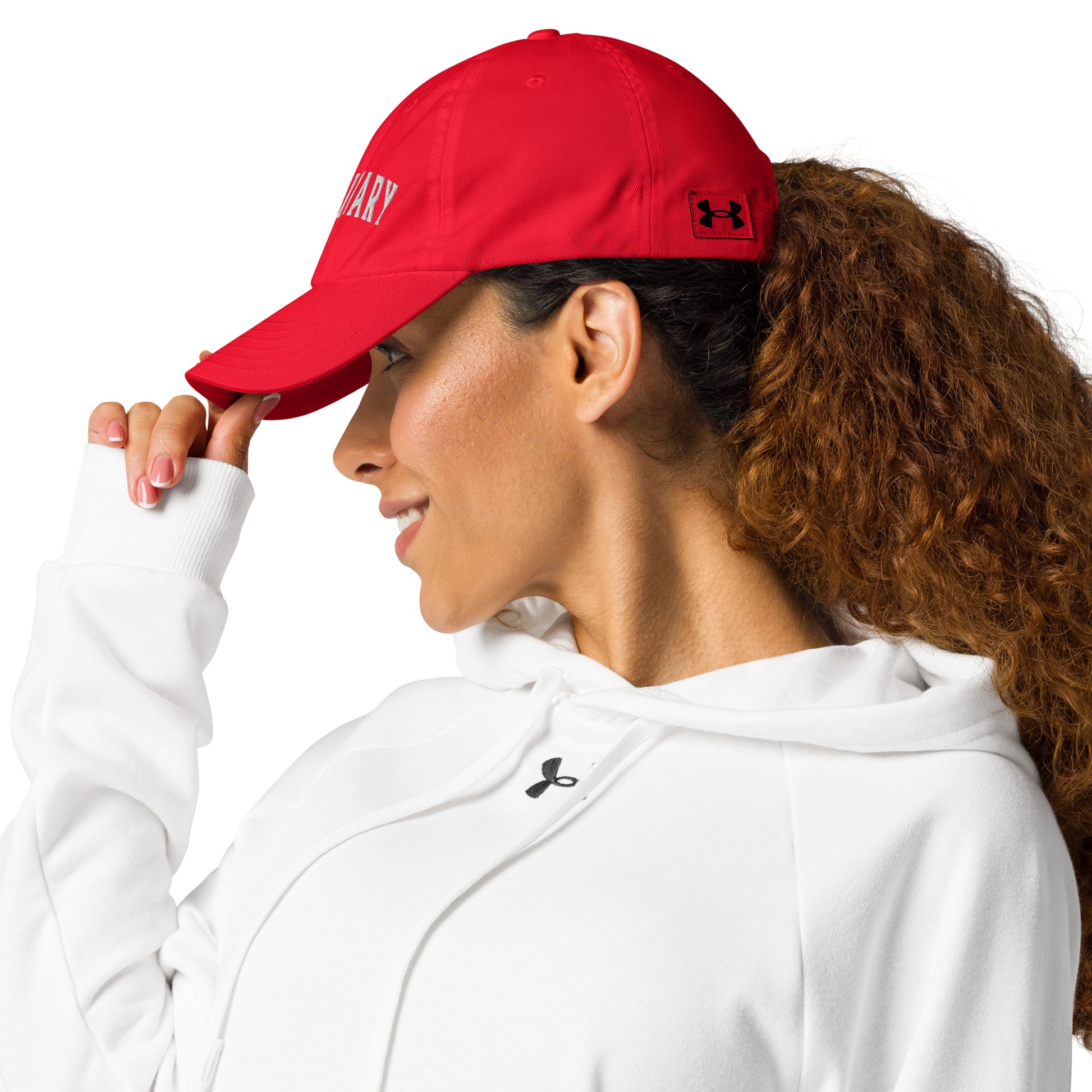 woman on red Visionary Under Armour® dad hat with embroidered logo, low-profile unstructured design, curved visor, and adjustable strap for focused, clear, and long-term disciplined everyday grind, product by Wear Grit Brand Clothing