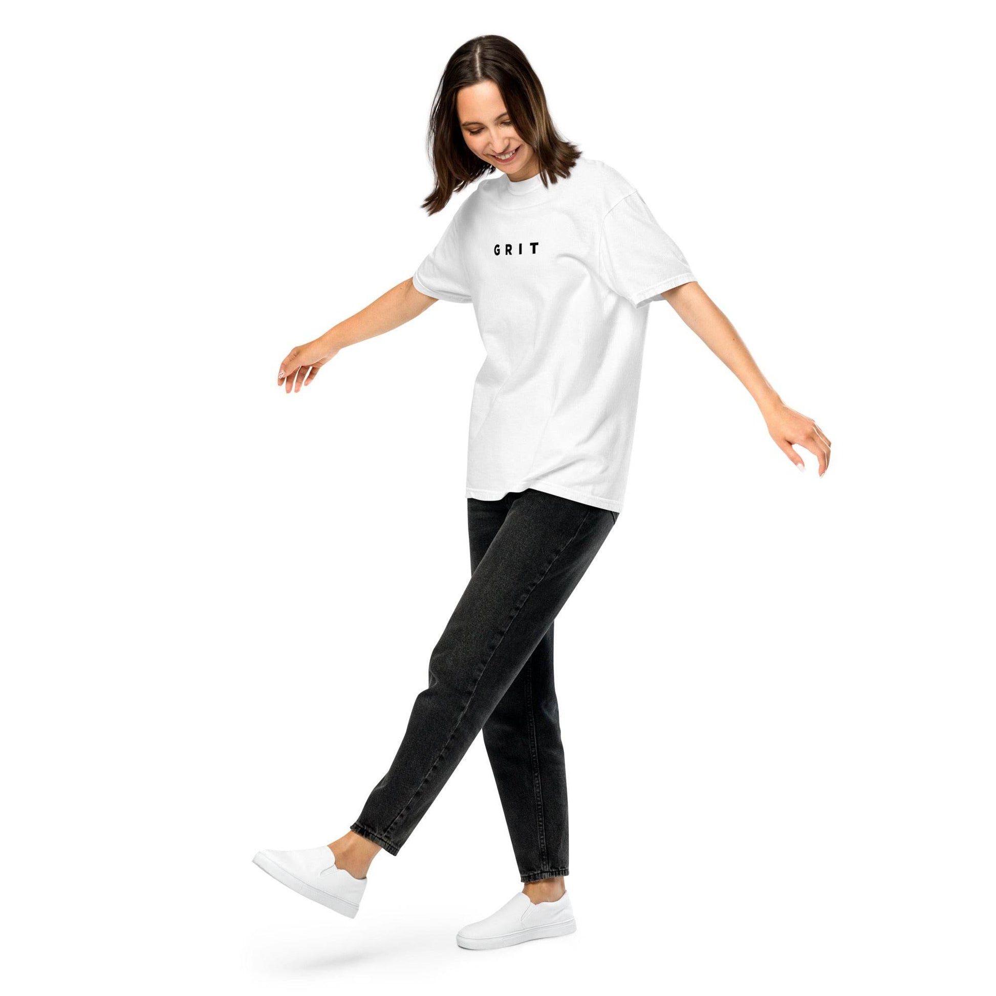 A woman wearing white Grit T-Shirt mindset-driven apparel designed for discipline, focus, consistency, and everyday growth by Wear Grit Brand